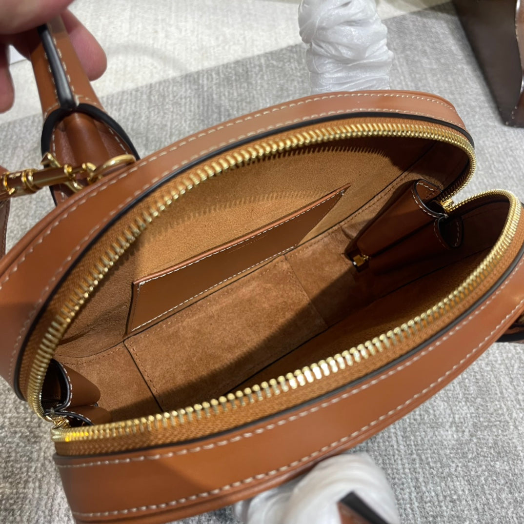 TRIOMPHE TOP HANDLE BAG 20 IN BRONZE BROWN CALFSKIN Amelia