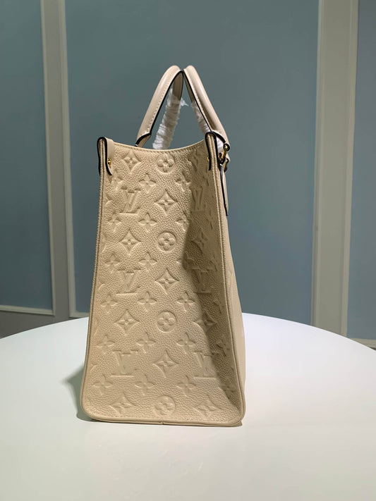 M45595 OnTheGo MM Monogram Empreinte leather white 35cm